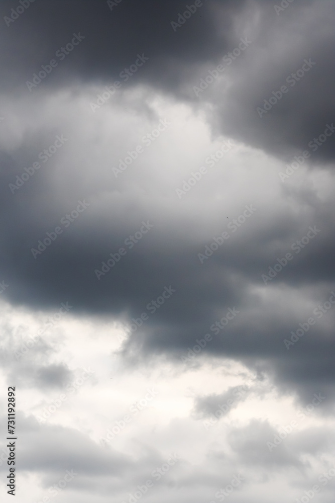 Fototapeta premium Black clouds in bright blue sky closeup