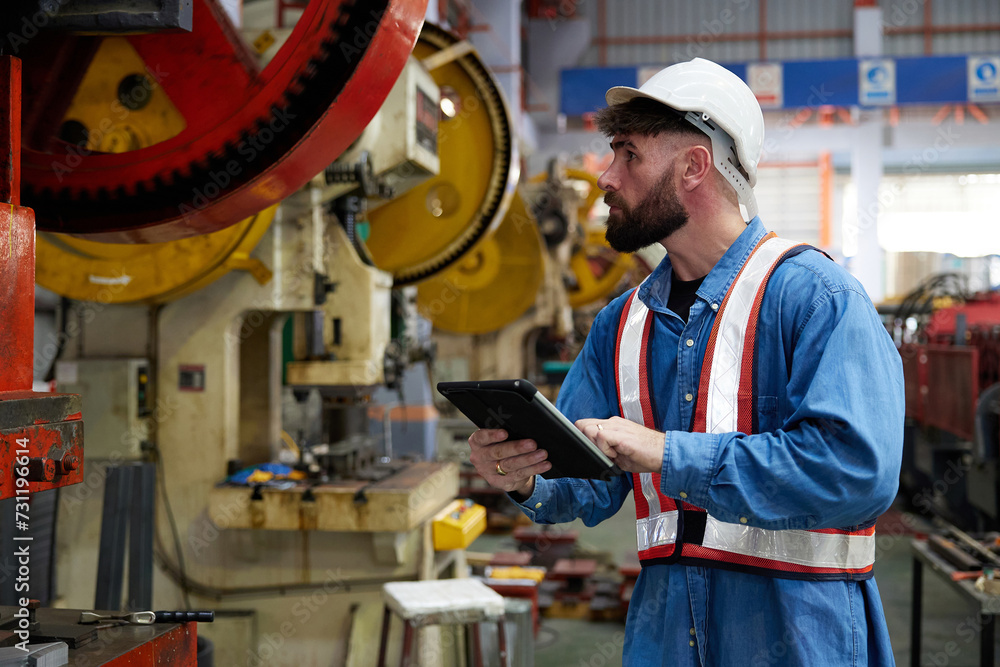 worker or engineer working on tablet and checking machine in the factory worker or engineer working on tablet and checking machine in the factory