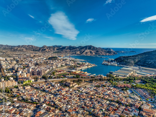 Aerial view of Cartagena port city in Spain surrounded by bastions and fortifications, medieval castle hill, roman amphitheater, bull ring, 