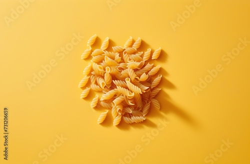 Italian pasta of different shapes on a yellow background,