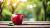 red apple rests on table, backdrop of nature, with space for caption