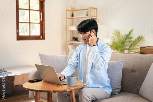 Businessman in casual is sitting comfortable sofa and wearing headphones to explaining business information photo