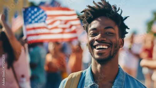  A cheerful young black man in casual attire joins a crowd of people waving flags while celebrating USA Independence Day.