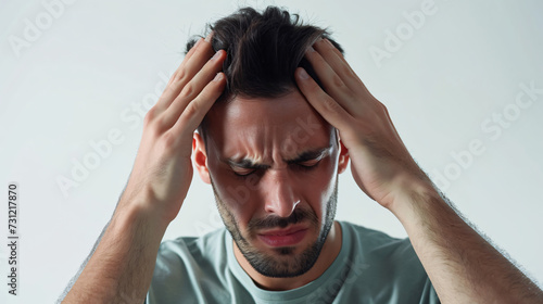 man holding his head in pain