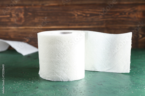 Roll of toilet paper on green table