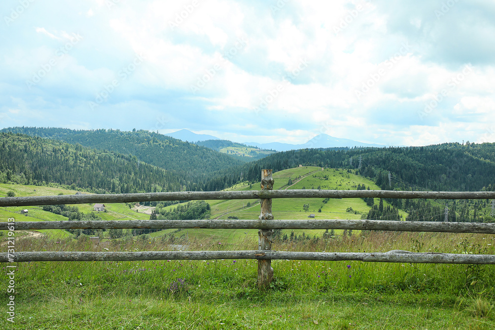 Wooden fence on mountain meadow in Carpathians, Ukraine