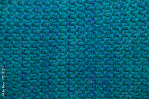 Knitted blue bright background close-up. Template design.