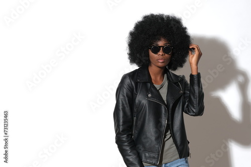 Fashionable woman in stylish outfit on isolated white background.