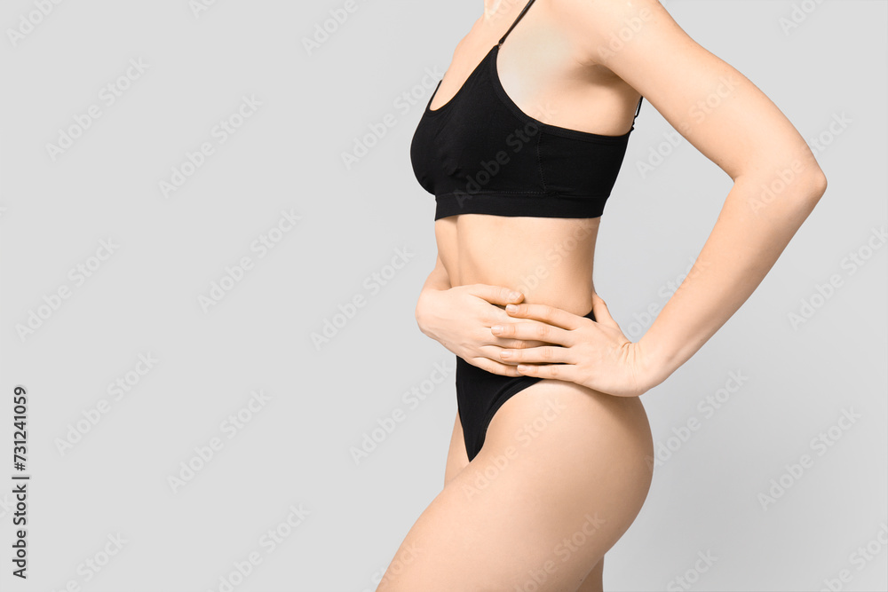 Pretty young woman in black cotton underwear on light background Pretty young woman in black cotton underwear on light background