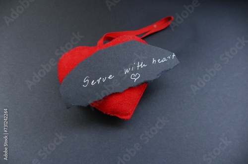 Serve with heart - heart and note with handwriting text