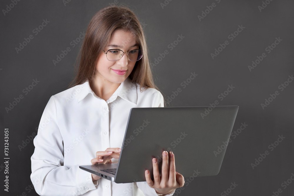 young student smiling, doing his homework on laptop young student smiling, doing his homework on laptop