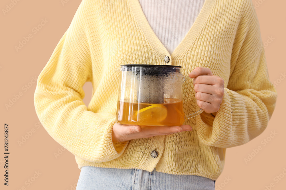Young woman with teapot on beige background, closeup Young woman with teapot on beige background, closeup