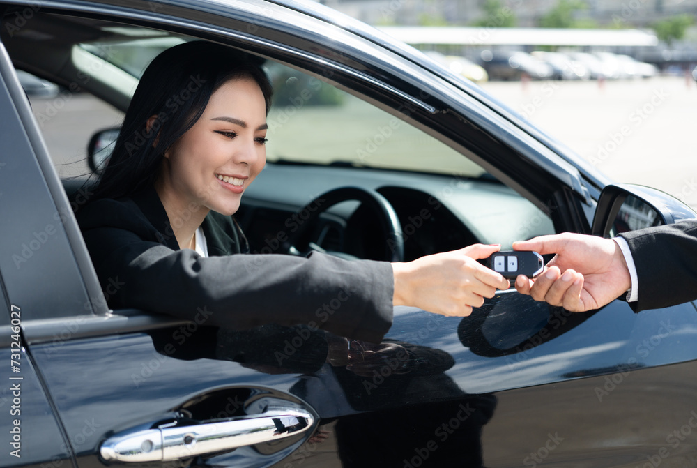 Young asian businesswoman buying new car with sale manager. she getting key and go to driving car very happy and proud. Buy sell rent concept. Hand sending key vehicle contract business car deal Young asian businesswoman buying new car with sale manager. she getting key and go to driving car very happy and proud. Buy sell rent concept. Hand sending key vehicle contract business car deal