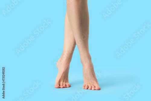 Barefoot woman on blue background