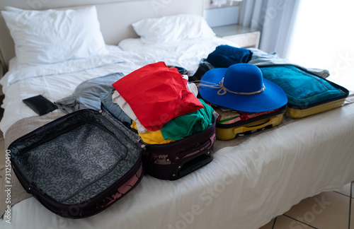 Suitcase with clothes on the bed. Preparing for vacation.