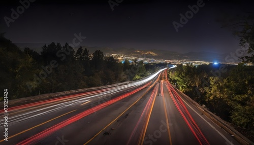 traffic on highway reaching the city by night, long exposure 