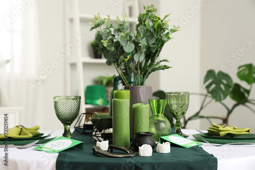 Festive table serving with candles in dining room, closeup. St. Patrick's Day celebration