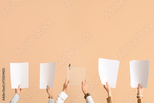 Hands with voting papers and ballot box on beige background. Election concept