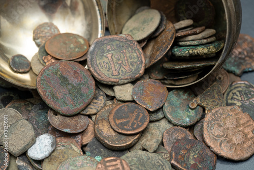 A collection of antique coins, relics, historical artifacts of the past from bygone eras.