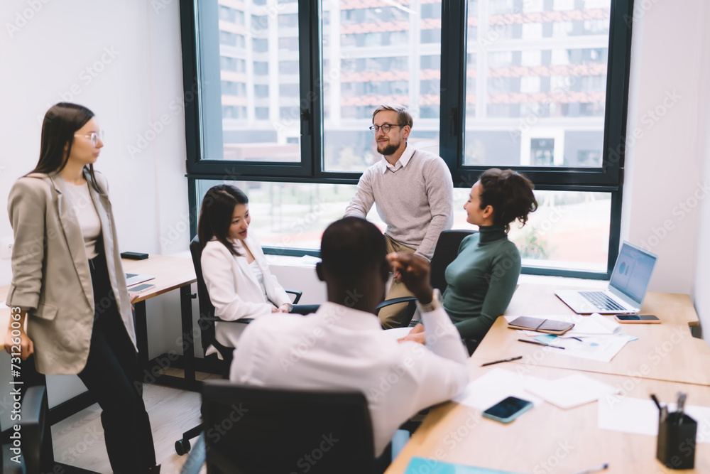 Group of diverse colleagues discussing project in office
