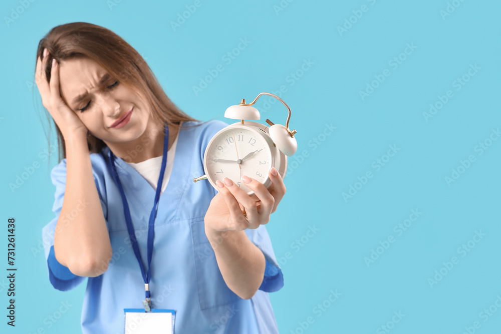 Stressed female doctor on blue background Stressed female doctor on blue background
