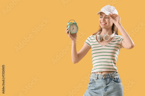 Young woman with alarm cloc...