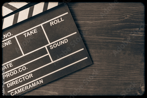 Vintage photo of movie clapper on wooden background, closeup, top view, copy space