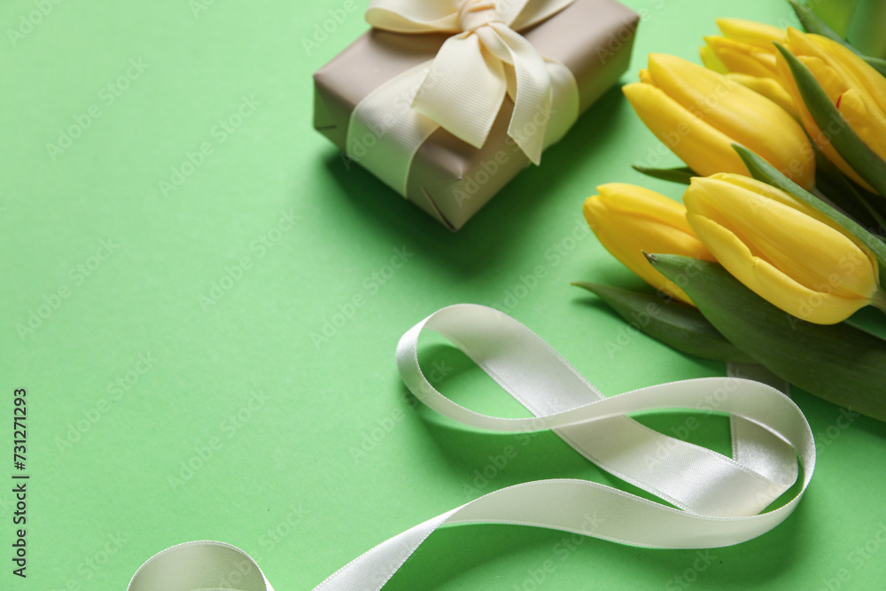 Composition with figure 8 made of ribbon, flowers and gift box on green background. International Women's Day celebration Composition with figure 8 made of ribbon, flowers and gift box on green background. International Women's Day celebration