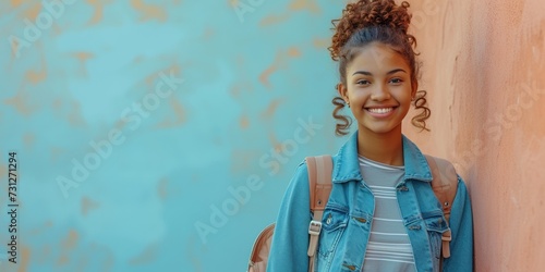 Happy young African American woman smiling confidently in casual outdoor portrait against colorful background.