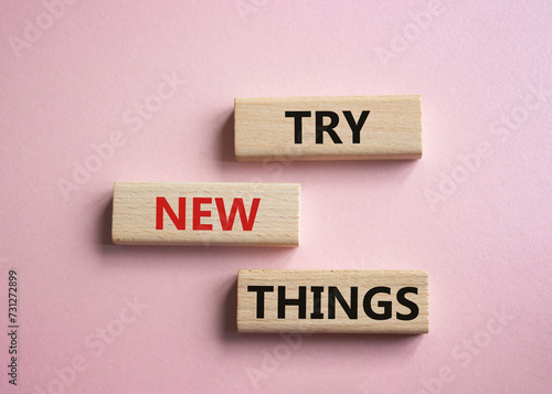 Try new Things symbol. Concept words Try new Things on wooden blocks. Beautiful pink background. Business and Try new Things concept. Copy space.