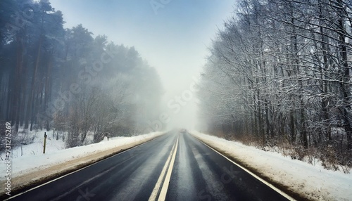 bad weather driving foggy hazy country road motorway road traffic winter time and snow