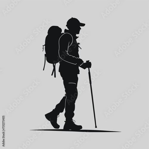 Silhouette of a male hiker with a backpack and walking stick on a minimalist gray background.