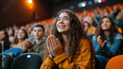 Joyful Young Woman Applauding at a Live Performance in Theater