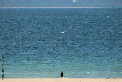 mulher caminhando na areia nas Dunas do Velho Chico, em casa Nova, Bahia, às margens do Rio São Francisco  photo