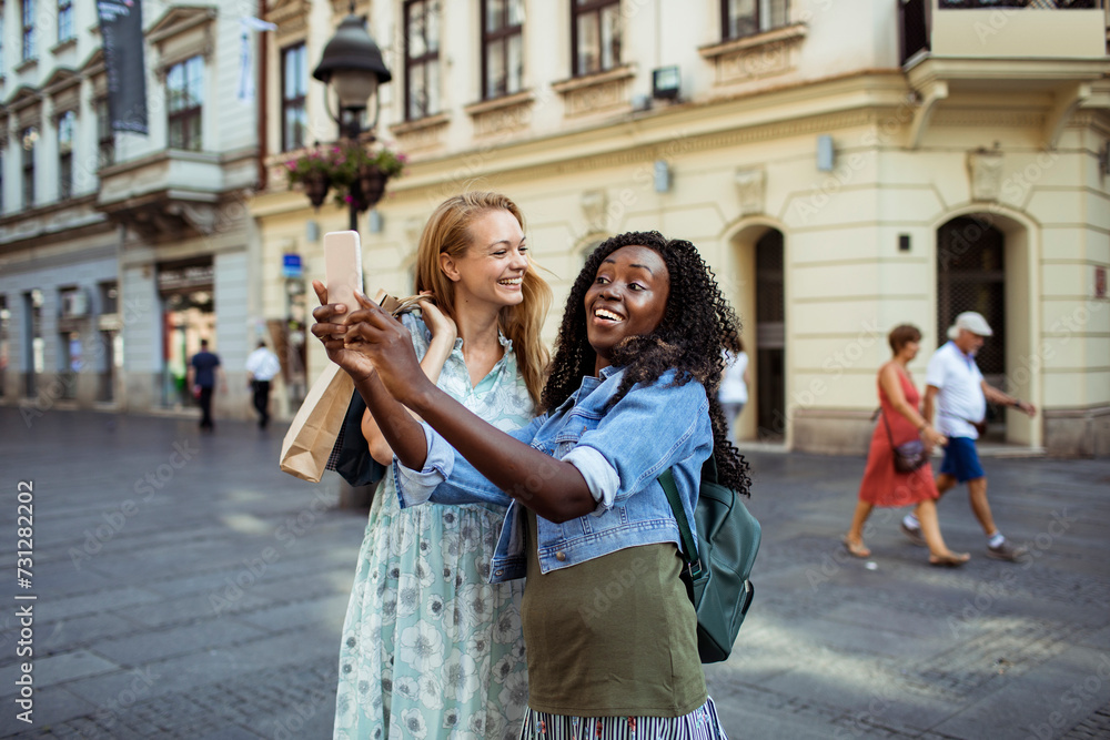 Two young diverse women shopping together in city Two young diverse women shopping together in city