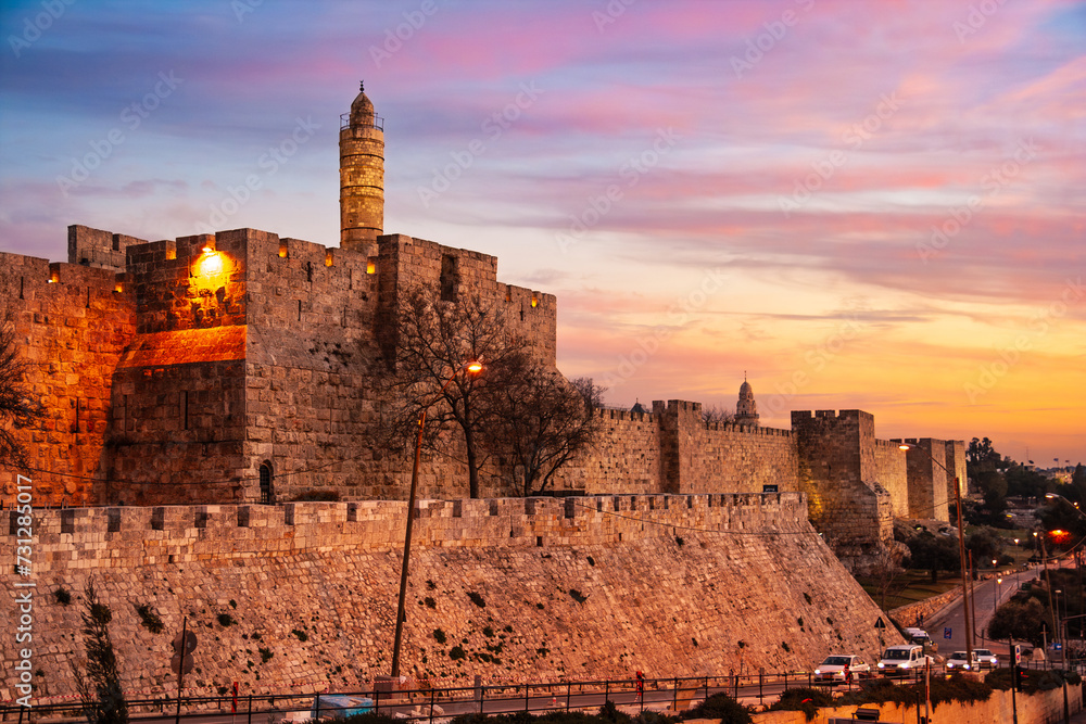 Fototapeta premium View of the old city wall of Jerusalem on the Tower of David and traffic around the city centre. Jerusalem, Israel