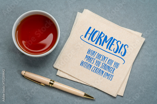 hormesis concept on a napkin, biological phenomenon where exposure to low doses of a stressor or toxin can have a beneficial effect on an organism photo