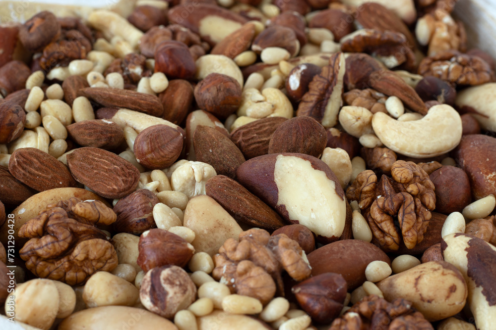 Close-up of mixed nuts (hazelnut, almond, walnut, Brazil, and pine nuts). Brain food, healthy fats, plant-based snack concept. Selective focus. Close-up of mixed nuts (hazelnut, almond, walnut, Brazil, and pine nuts). Brain food, healthy fats, plant-based snack concept. Selective focus.