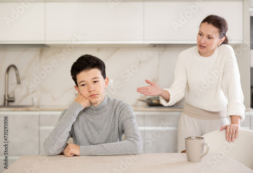 Mother and son arguing, son is upset and unhappy