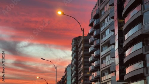 A beautiful view of the buildings along the Rambla in Montevideo, Uruguay, with a stunning sunset in the background. photo