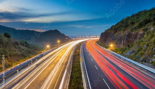speed traffic light trails on motorway highway at night