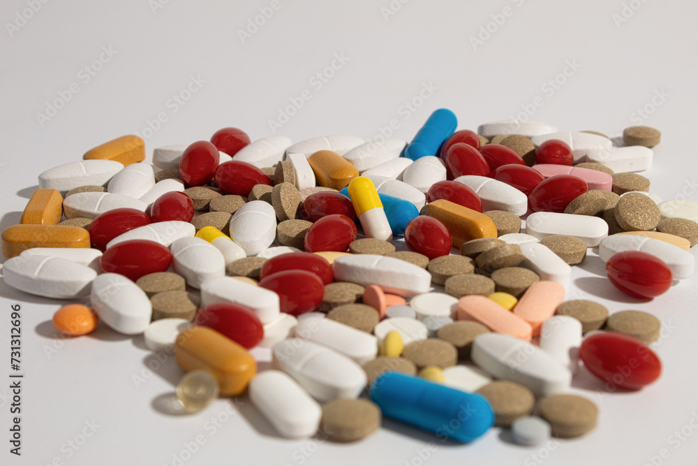 Close-up, Pills scattered on the table. Many pills of different colors and shapes Close-up, Pills scattered on the table. Many pills of different colors and shapes