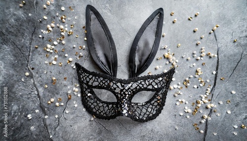 black sexy lace face mask with bunny ears and rhinestones for halloween party on grey background top view