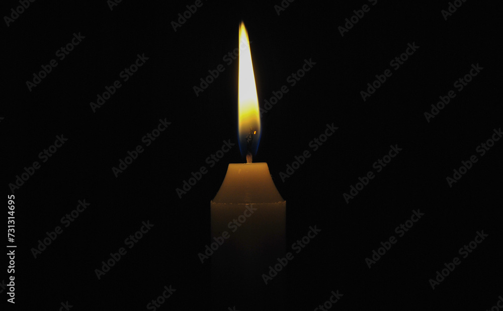 candle in the dark. candle burns on a black background candle in the dark. candle burns on a black background