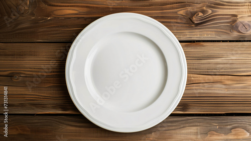 A minimalist white plate sits elegantly on a rustic wooden table, inviting culinary creativity. With a blank surface, this mockup is ideal for showcasing your mouthwatering dishes and inspir photo