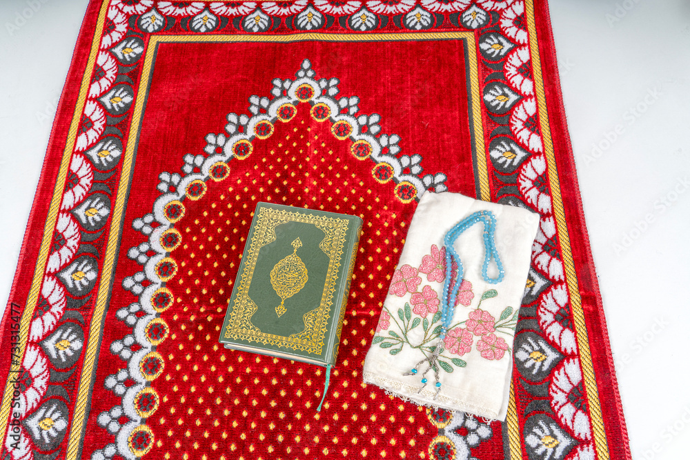 Rahle with Quran and Rosary on Muslim prayer rug.Ramadan Concept Rahle with Quran and Rosary on Muslim prayer rug.Ramadan Concept