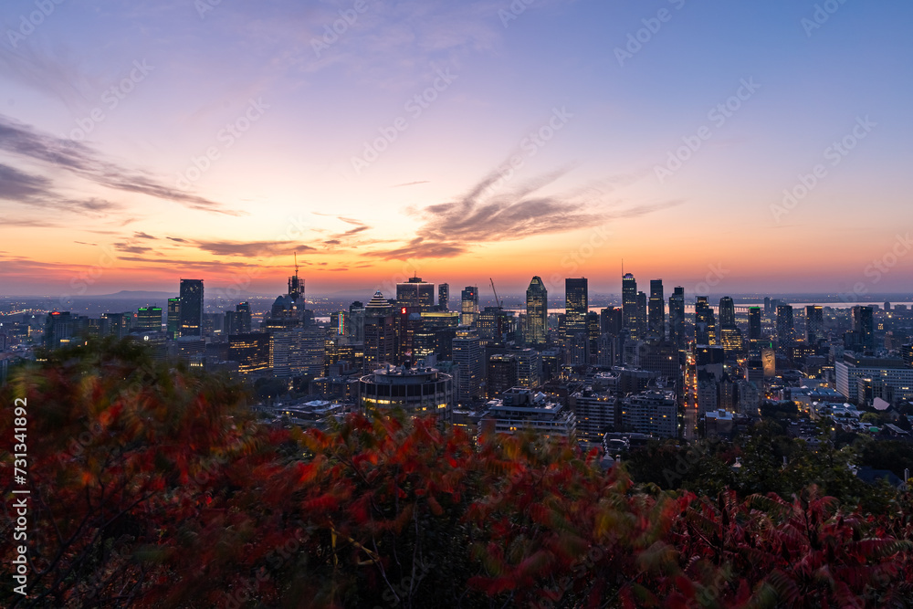 Montreal sunrise from Mont Royal Kondiaronk Belvedere with colorful leaves. Panoramic skyline view of downtown Montreal from top view at sunrise in Canada