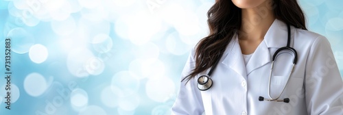 Experienced female doctor with stethoscope in hospital on blurred magical background with text space photo