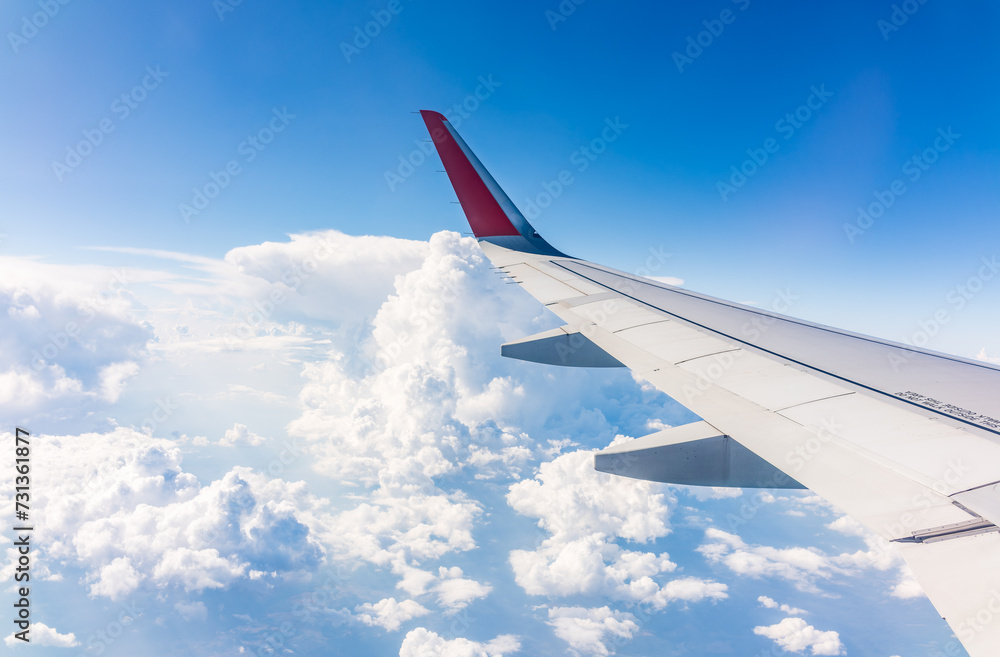 View from the airplane window at a beautiful cloudy sky and the airplane wing View from the airplane window at a beautiful cloudy sky and the airplane wing