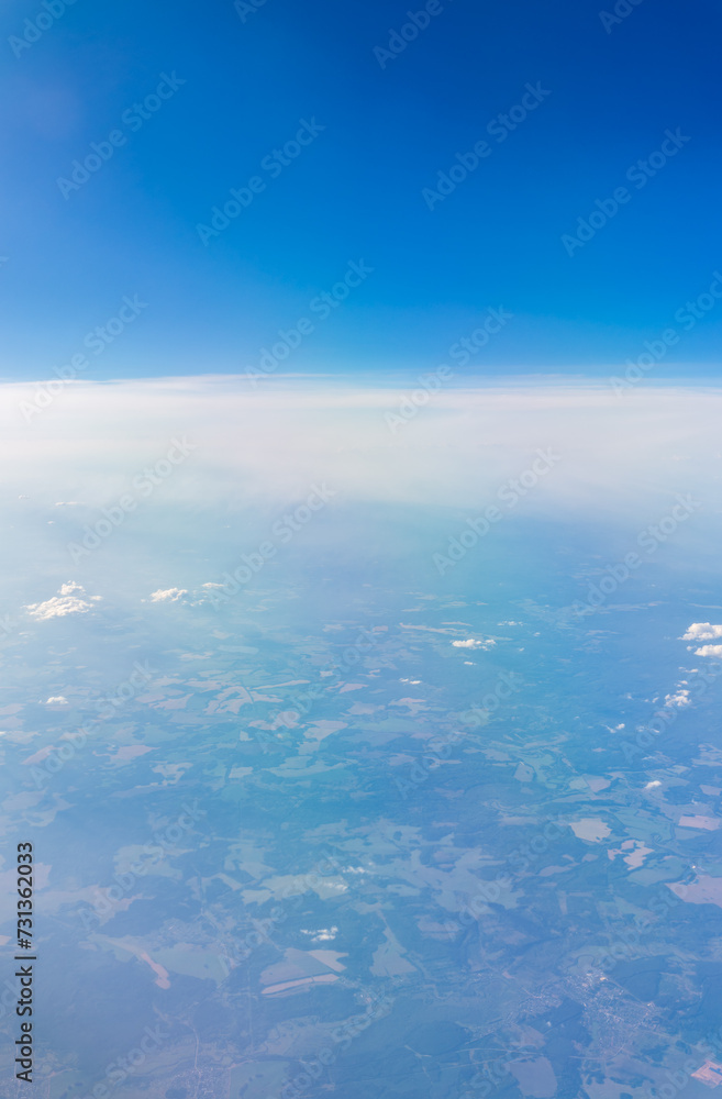 View from the airplane window at a beautiful cloudy sky and the airplane wing View from the airplane window at a beautiful cloudy sky and the airplane wing